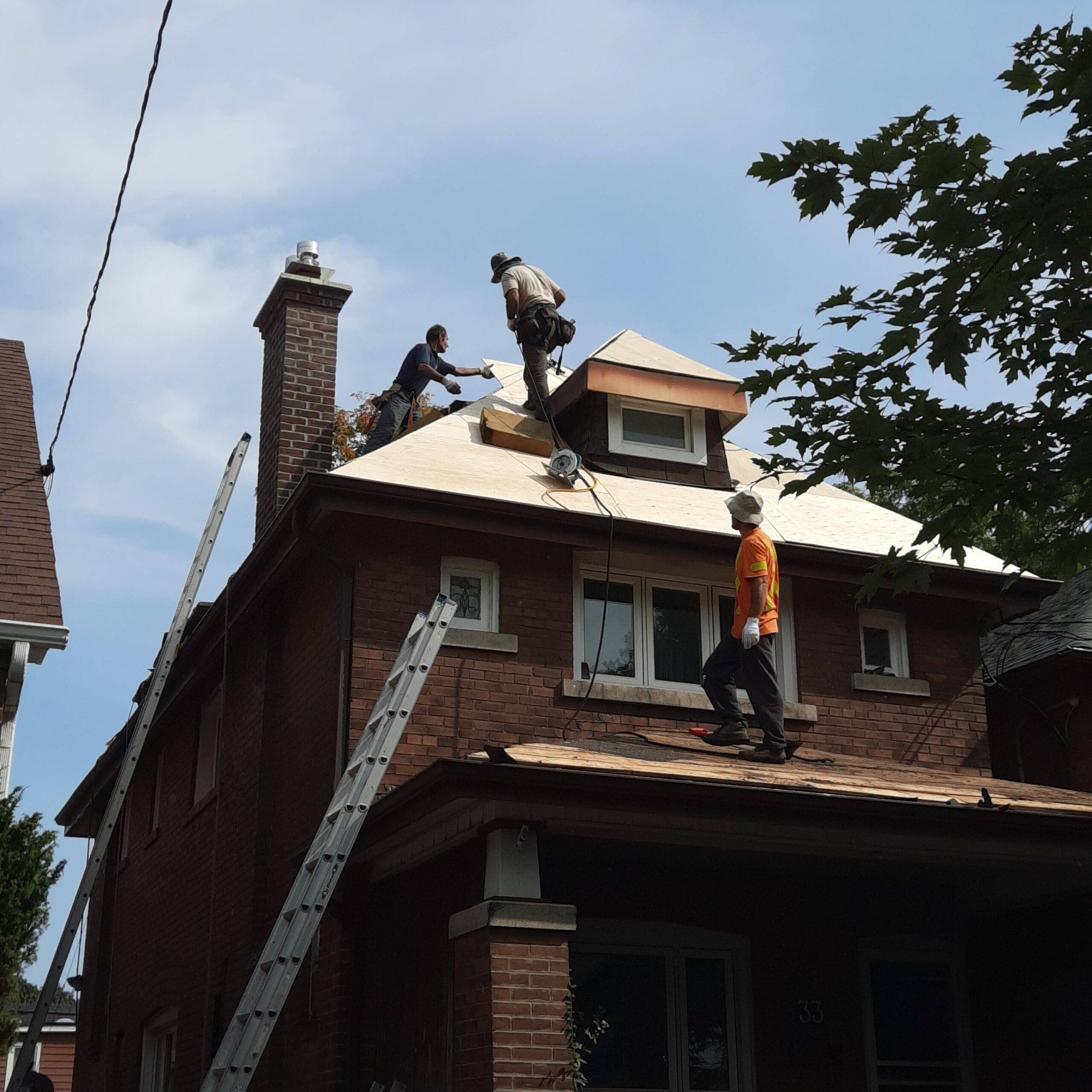 Residential roofing crew installing asphalt shingles in Toronto
