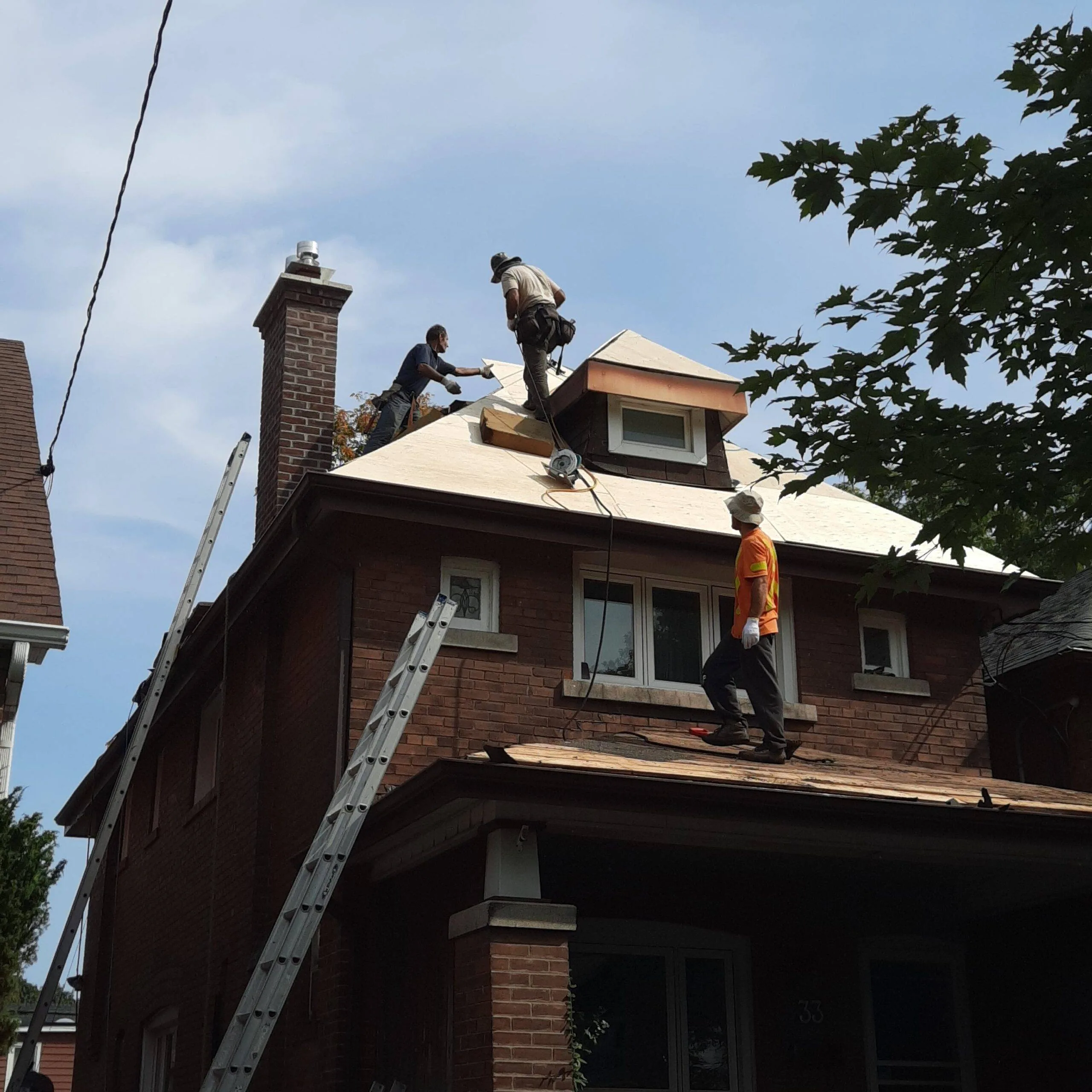 Residential roofing crew installing asphalt shingles in Toronto